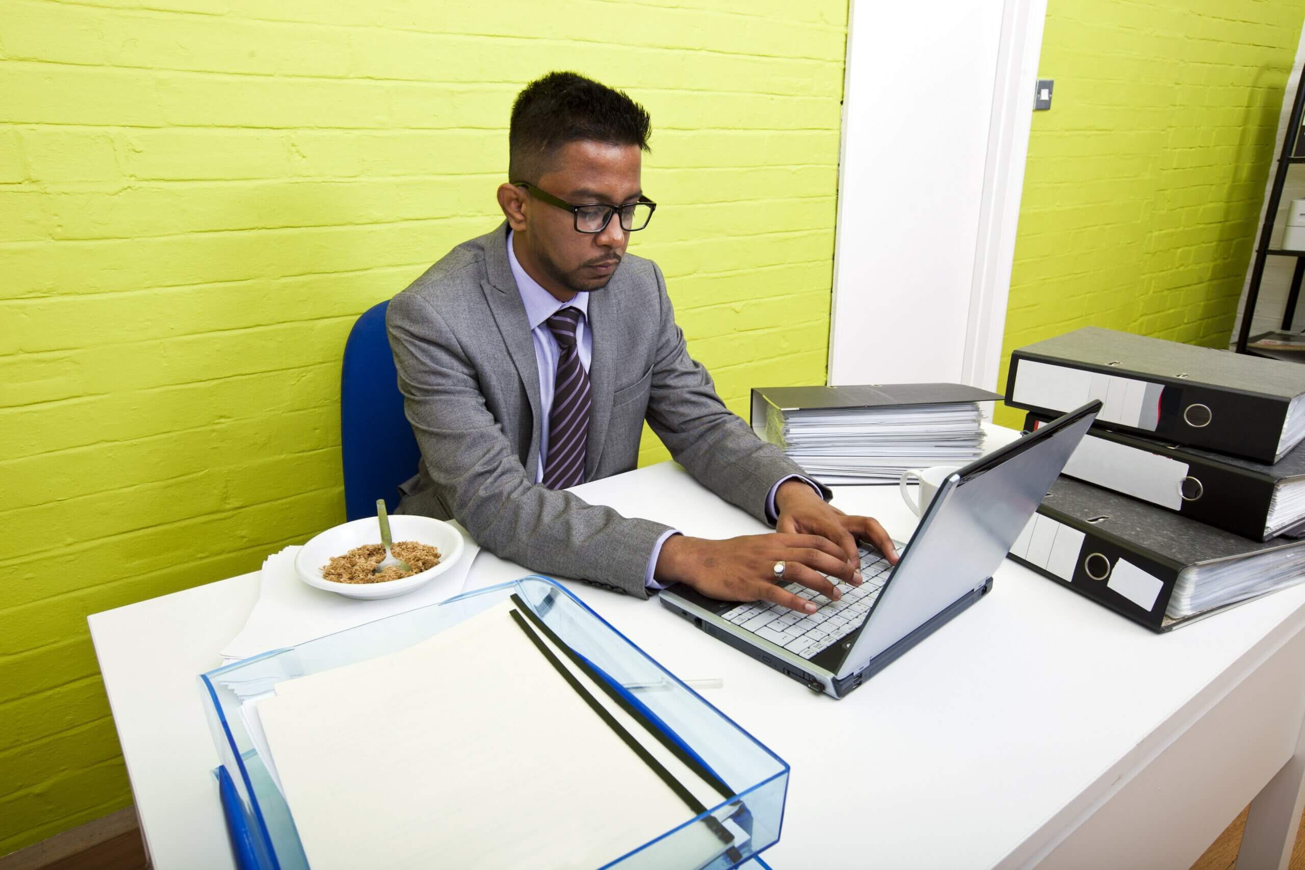 Photo of Indian businessman working on his laptop computer at his desk